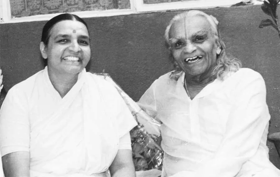 Black-and-white photograph of Geeta S. Iyengar and B.K.S. Iyengar sitting together, both smiling